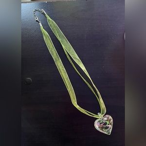 Glass heart necklace on ribbon.